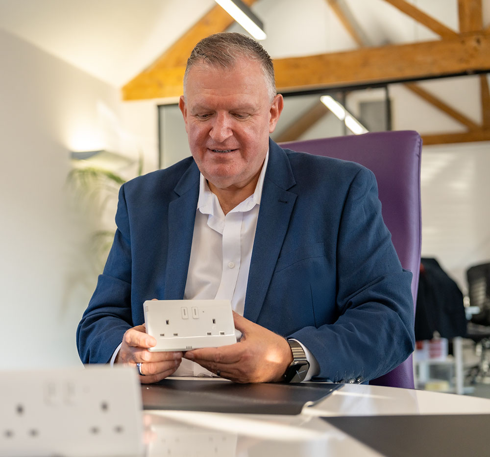 Founder Anthony Parfitt presenting a Ci Global safe socket in an office setting